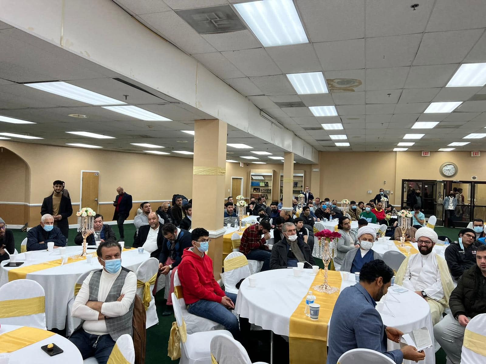 Community members gathered around tables at IAC