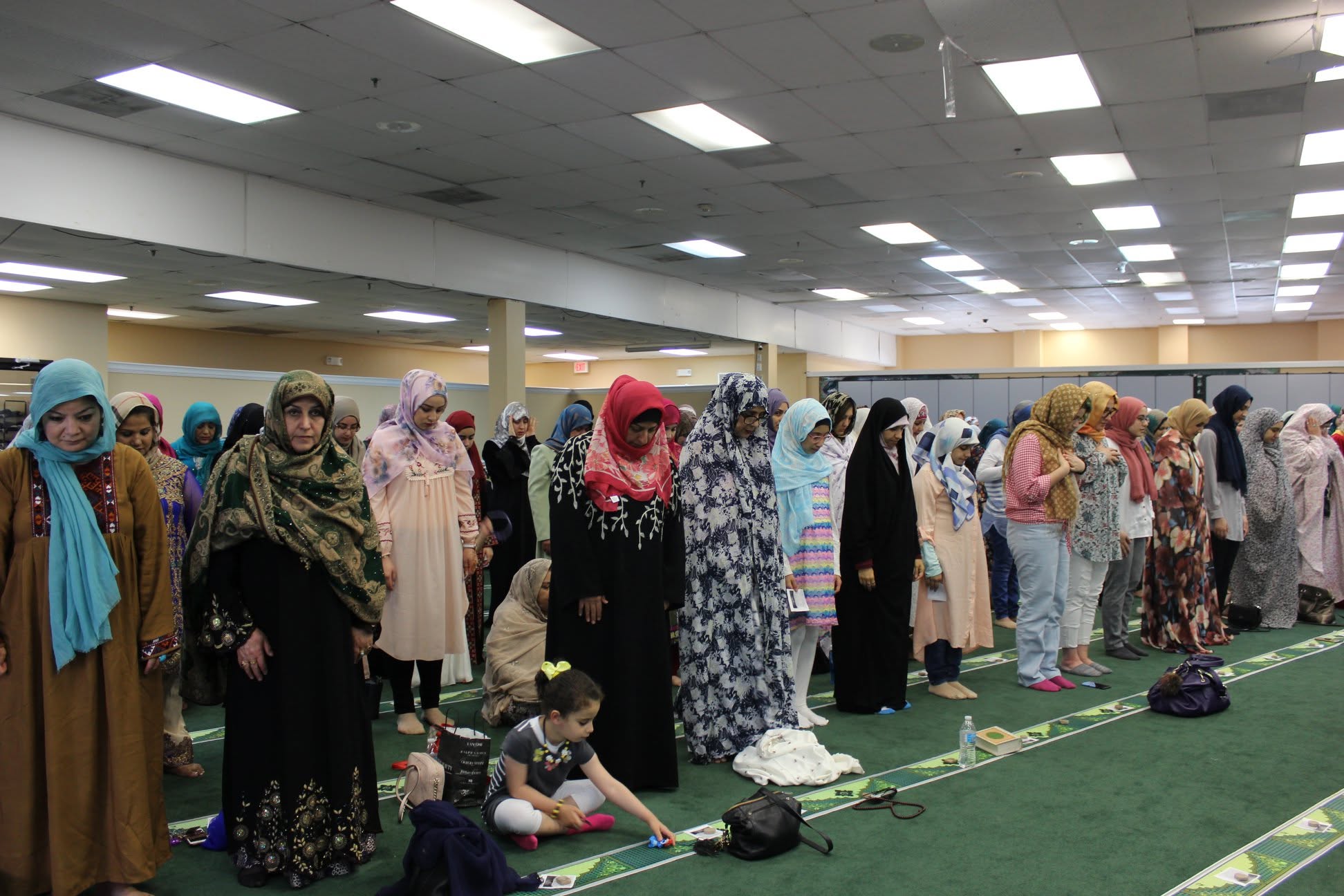 Families standing together in Eid prayer at Imam Ali Center